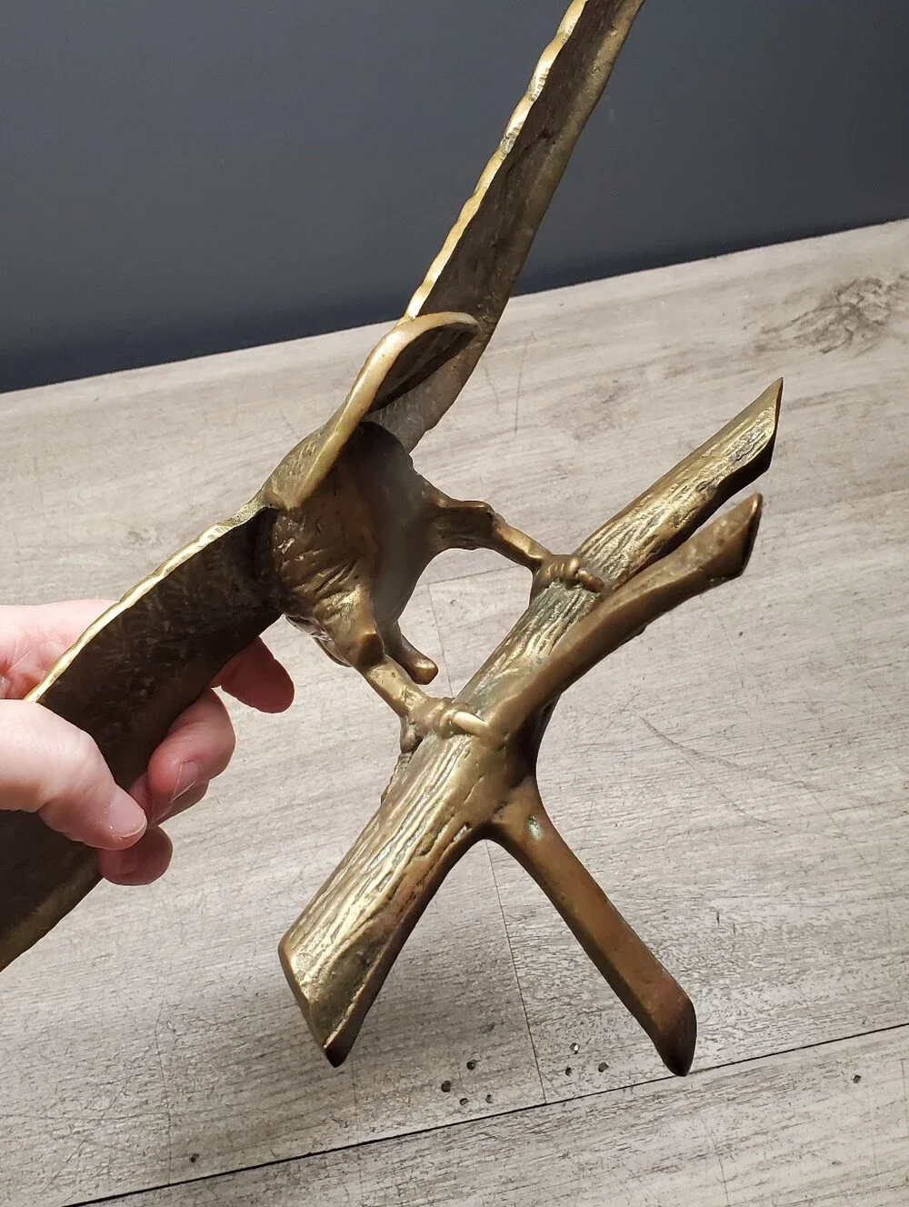 Vintage brass eagle statue perched on a tree branch